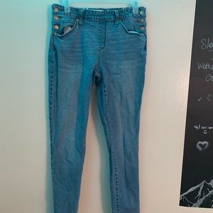 blue jeans, frayed ends and buttons on either side